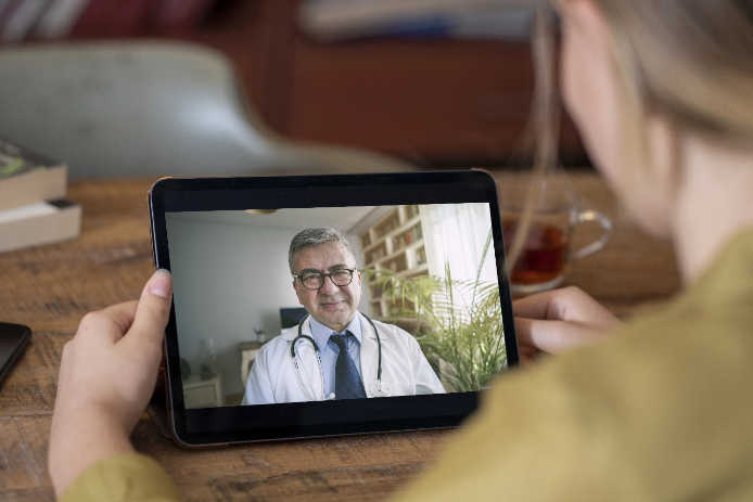 Woman on an ipad with a doctor