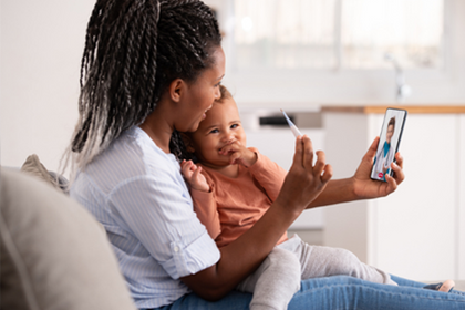 A woman and child looking at a phone